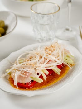 Sophisticated Fish ceviche in modern restaurant interior. Ceviche or Cebiche is a fish dish of the cuisine of Peru