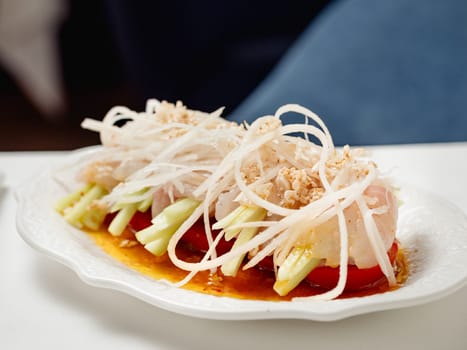 Sophisticated Fish ceviche in modern restaurant interior. Ceviche or Cebiche is a fish dish of the cuisine of Peru