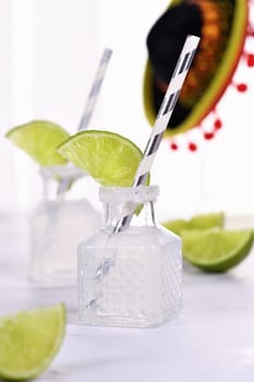 Classic alcoholic cocktail Margarita. Served in mini bottles with salt and lime. An original idea for a buffet event.