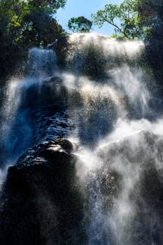 Waterfall running down the mountain with water splashing over the rocks in Minas Gerais, Brazil