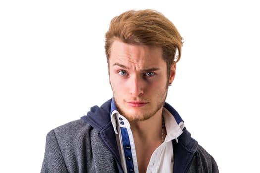 A young man with a concerned look on his face. Photo of a worried young man with an expression of concern on his face