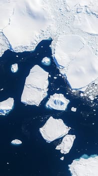 Icebergs are floating in dark blue water near melting glacier, creating beautiful arctic landscape