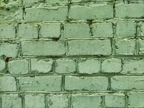 This textured green brick wall provides a versatile backdrop with enough space for text and creative layouts, ideal for various projects.