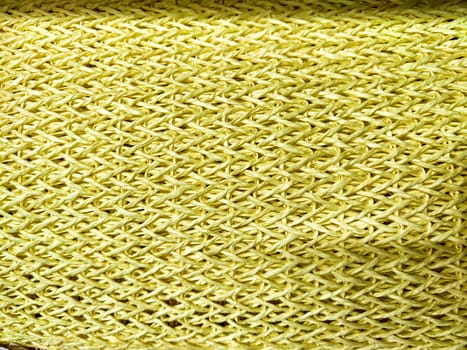A woven yellow fabric showcases a detailed texture and pattern, providing a vibrant backdrop for text and creative projects.