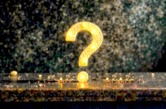 A glowing question mark stands alone on a surface, representing confusion and the quest for solutions amidst difficulties.. Blurred picture