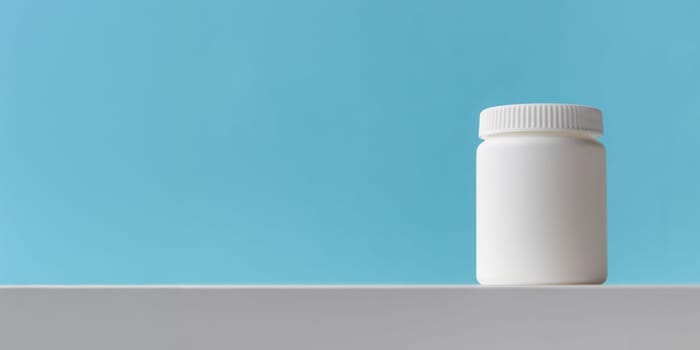 White plastic medicine bottle on a blue background with copy space. Medicine and health concepts include a jar with pills or vitamins. High-quality photo mock-up banner. Healthy Bio Supplements