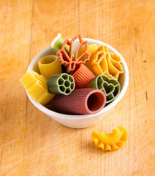 Multicolored italian pasta in bowl