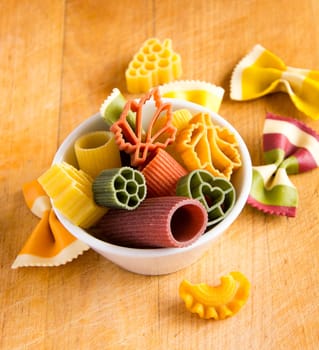 Multicolored italian pasta in bowl