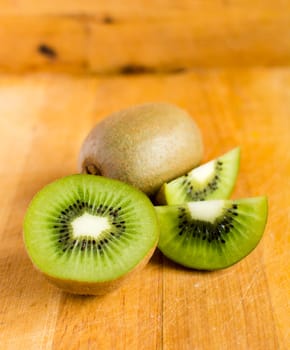 Fresh kiwis on wooden ground