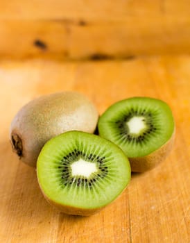 Fresh kiwis on wooden ground