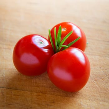 tomatoes on brown textured wood
