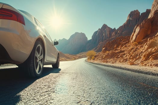 A white car parked on a smooth desert road beneath a radiant sun, framed by towering mountains, showcasing a tranquil travel scene ideal for adventure and exploration.