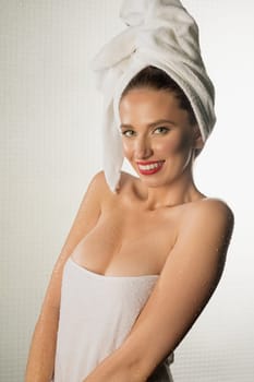 Happy girl wrapped in towel after shower cropped portrait against white background