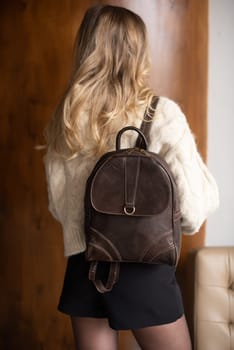 photo of a brown leather backpack with retro look. indoors photo