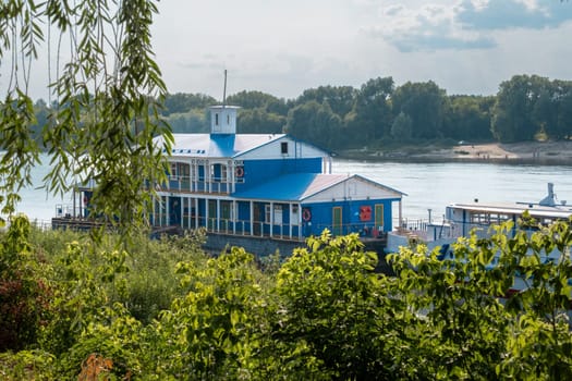 Pavlovo, Nizhny Novgorod Region, Russia - 07.17.2024. Landing stage with a tourist boat on the Oka River.