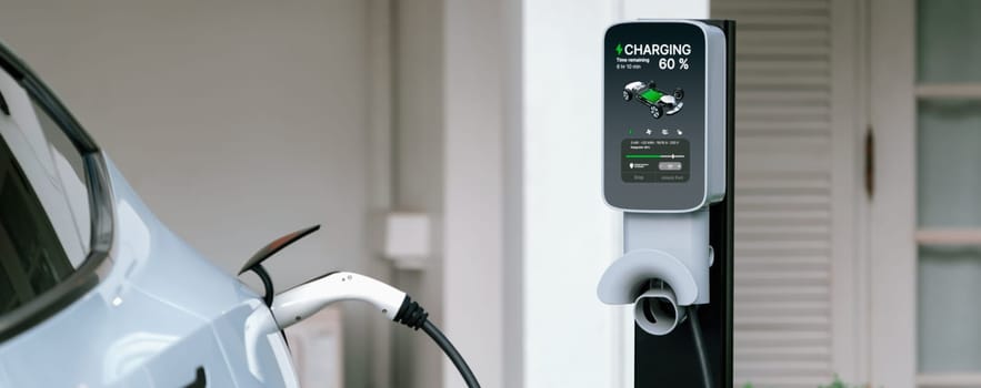 Electric vehicle technology utilized to residential home charging station for EV car battery recharge. Eco-friendly transport by clean and sustainable energy for future environment.Panorama Synchronos