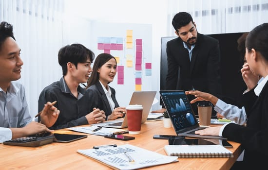 Businessman presenting data analysis dashboard display on TV screen in modern meeting for marketing strategy. Business presentation with group of business people in conference room. Concord