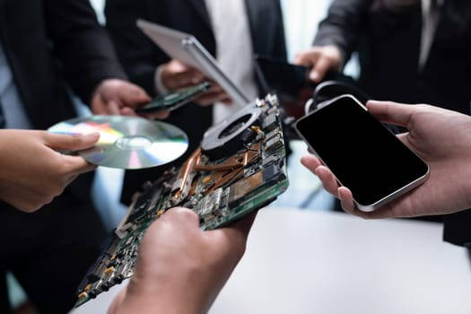 Business people holding electronic waste as eco-business recycle waste policy in corporate responsibility. Reuse, reduce and recycle for sustainability environment. Quaint