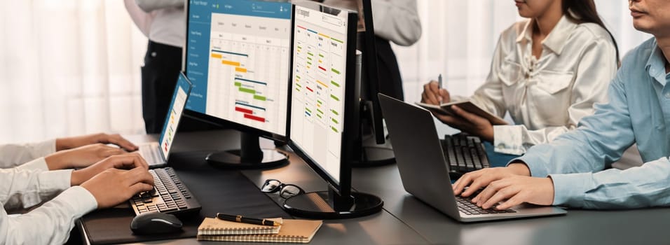 Project management team coordinating and update project planned schedule on computer using Gantt chart software in office. Business people planning time and deadline for company task. Trailblazing