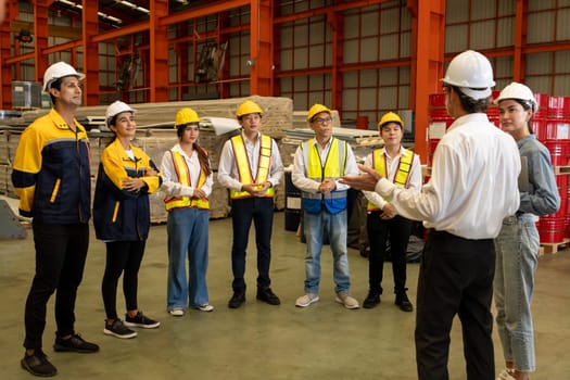 Collective factory worker and engineer gather for meeting with factory executive or manager, discussing plan and industry training program on-site work heavy industrial steel workshop. Exemplifying