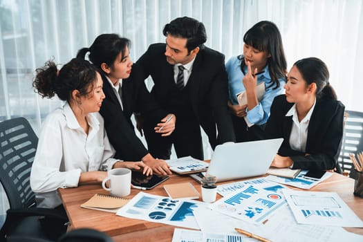 Diverse group of business analyst team analyzing financial data report paper on office table. Chart and graph dashboard by business intelligence analysis for strategic marketing planning Habiliment