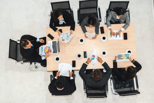 Business people group meeting shot from top view in office . Profession businesswomen, businessmen and office workers working in team conference with project planning document on meeting table . Jivy