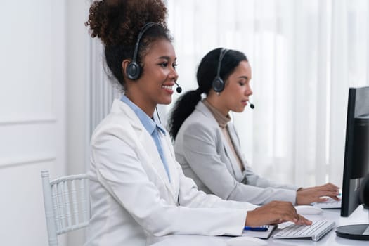 Business people wearing headset working in office to support remote customer or colleague. Call center, telemarketing, customer support agent provide service on telephone video conference call crucial