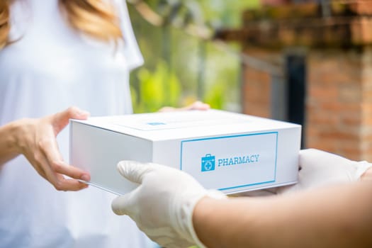 Delivery man give medicine drug to patient female at home, Sick Asian young woman receive medication first aid pharmacy box from hospital delivery service, healthcare medicine online concept