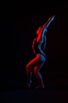 Portrait of a beautiful young woman gymnast training calilisthenics exercise with acrobatic element