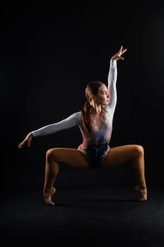 Portrait of a beautiful young woman gymnast training calilisthenics exercise with acrobatic element