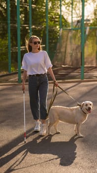 Blind woman walking with guide dog