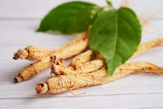 Ginseng roots and green leaf, organic nature healthy food.