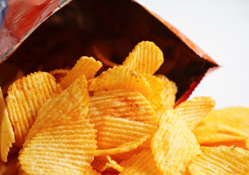 Potato chips in open bag, delicious BBQ seasoning spicy for crips, thin slice deep fried snack fast food.