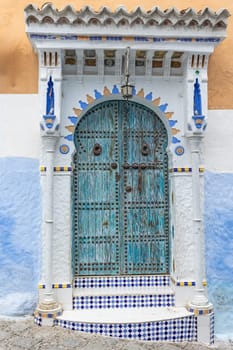 Ornate blue and white door closeup. Blue City of Chefchaouen. Morocco. Vertically. 