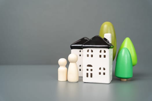 People figures near the house. Homes and real estate. Affordability, accessibility and sustainability.