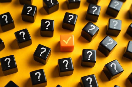 An orange check mark among many question marks. Correct answer. Task completion. Open achievement. Many unknown things and challenges. Fulfillment of requirements.