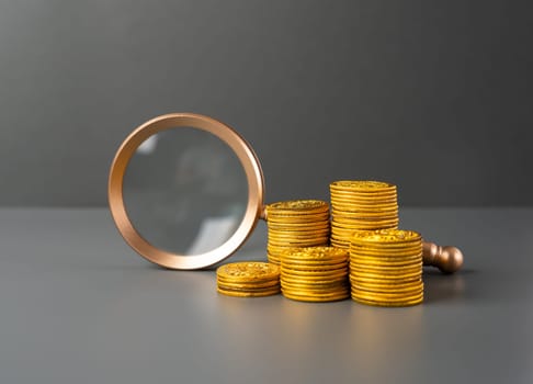 Magnifying glass and money coins stack. Search for financing and investment opportunities. Savings and deposits. Lending. Economy. Monetary policy, interest rates.