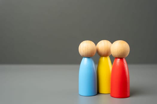 Three colored figures of people. Contact, communication and spending time. A team of people with different skills. Unity and work in teamwork. Recruiting new workers.