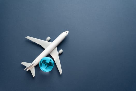 Airplane and blue globe. Travel and business trips. Transport system and infrastructure. Air communication. World flight routes. Development of civil aviation.
