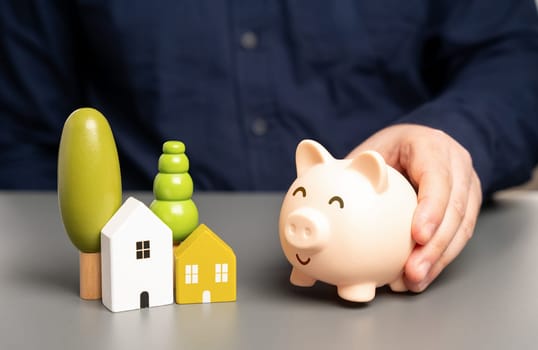 Home and a piggy bank. Budget and maintenance of buildings. Save money on your bills. Affordable housing, favorable mortgage. Reduced rates and load on your wallet.