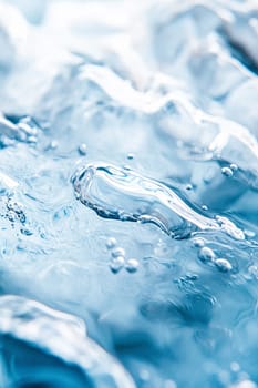 Close-up of rippling clear blue water with bubbles, beautifully illuminated, evoking purity and a serene atmosphere