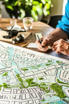 Urban planning team at a table, working on sketches and eco-conscious designs for future cities.