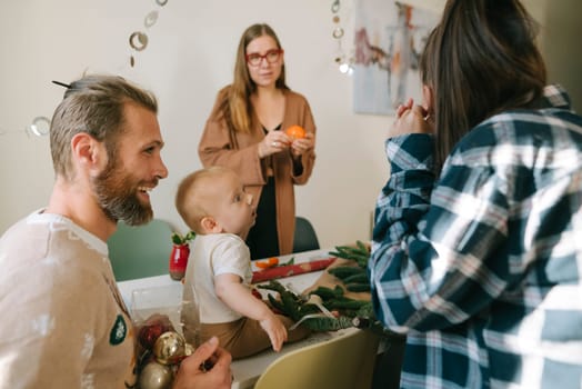 A joyful family celebration with a toddler, vibrant decorations, and warm interactions among loved ones