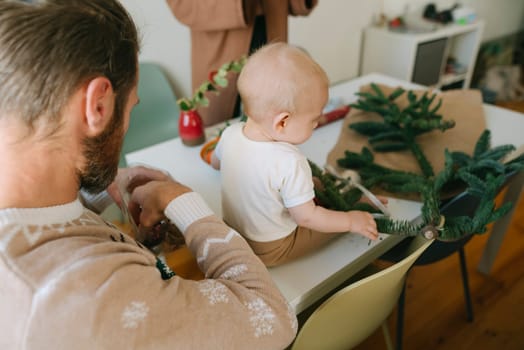 This is a nurturing moment spent crafting with a baby, beautifully showcasing the joy of family bonding and creativity