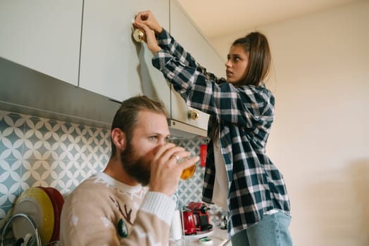 A joyful couple shares a delightful moment together in their stylish kitchen, showcasing everyday life