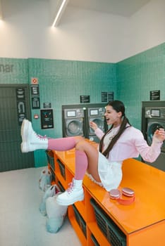 A fashionable woman enjoys her time at a laundromat, showcasing modern fashion trends while having fun