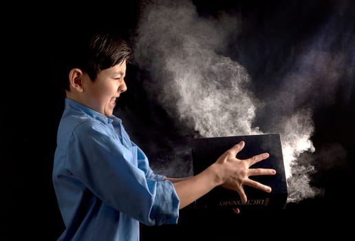A young boy slams a book with powder in it in this conceptual image.