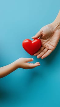Adult and child hands exchanging a heart on blue background.