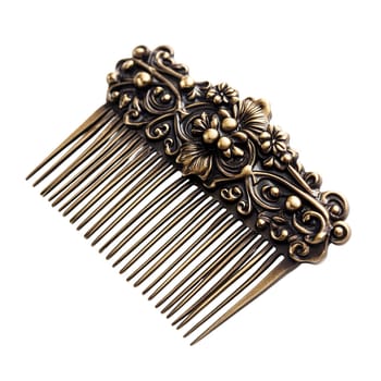 Antique ornate gold-colored hair comb with floral design isolated on white background.