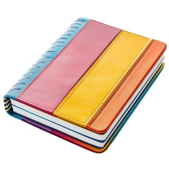 A colorful spiral notebook with a leather cover lies on a white background, ready for notes and ideas.